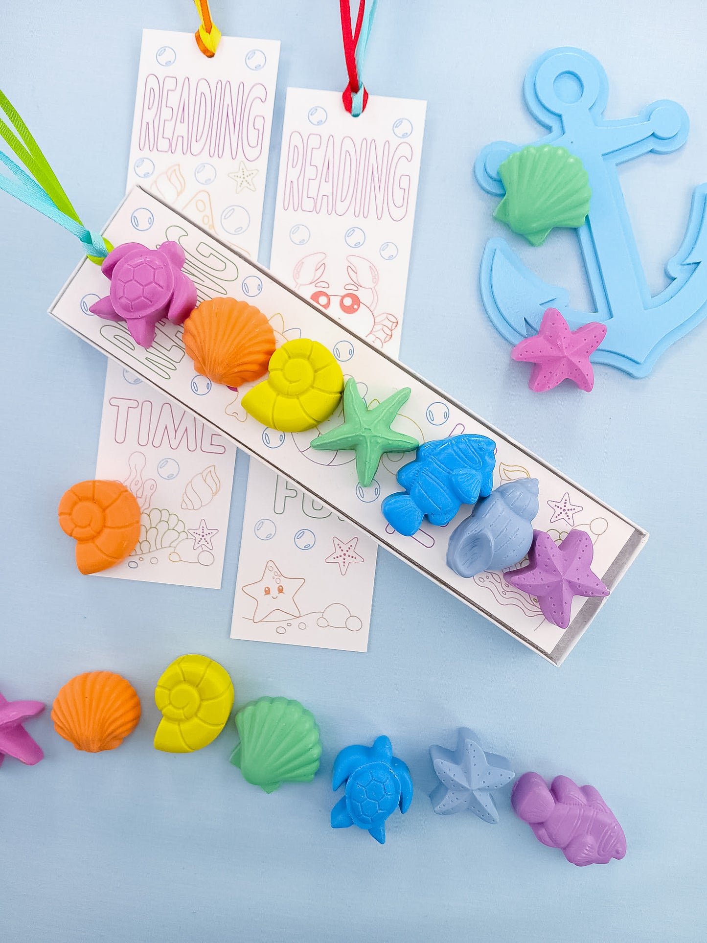 Pastel sea creatures turtle, shell, fish, and starfish crayons with anchor decor and ocean coloring bookmark, handmade kids party favors.