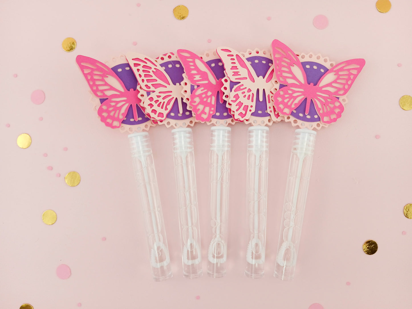 Fuchsia and light pink butterfly party bubble wands with purple accents, perfect for garden-themed birthday parties or whimsical girl party favors