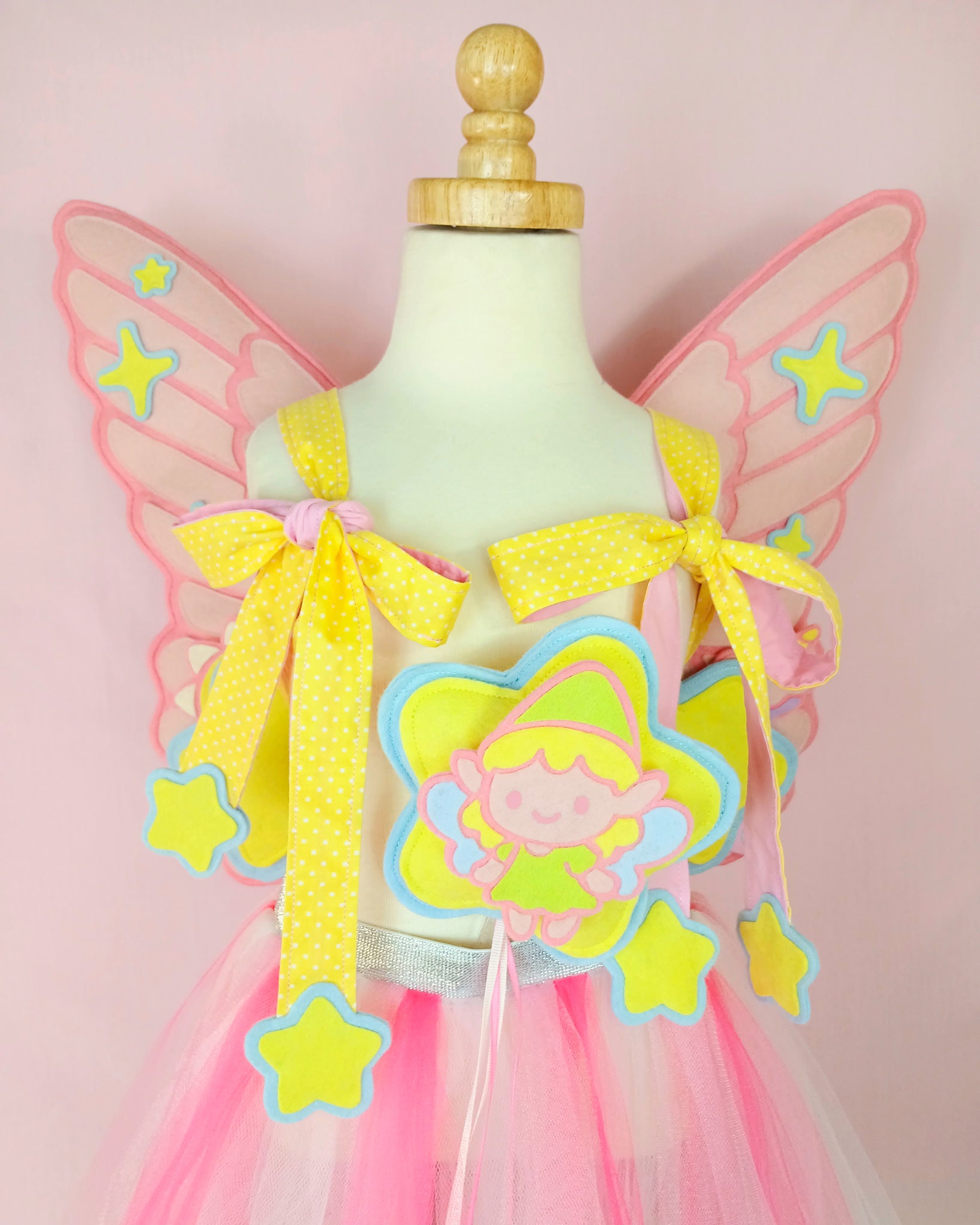 Premium bespoke fairy wings in wool felt with unicorn charm and polka dot straps, heirloom costume for birthdays.
