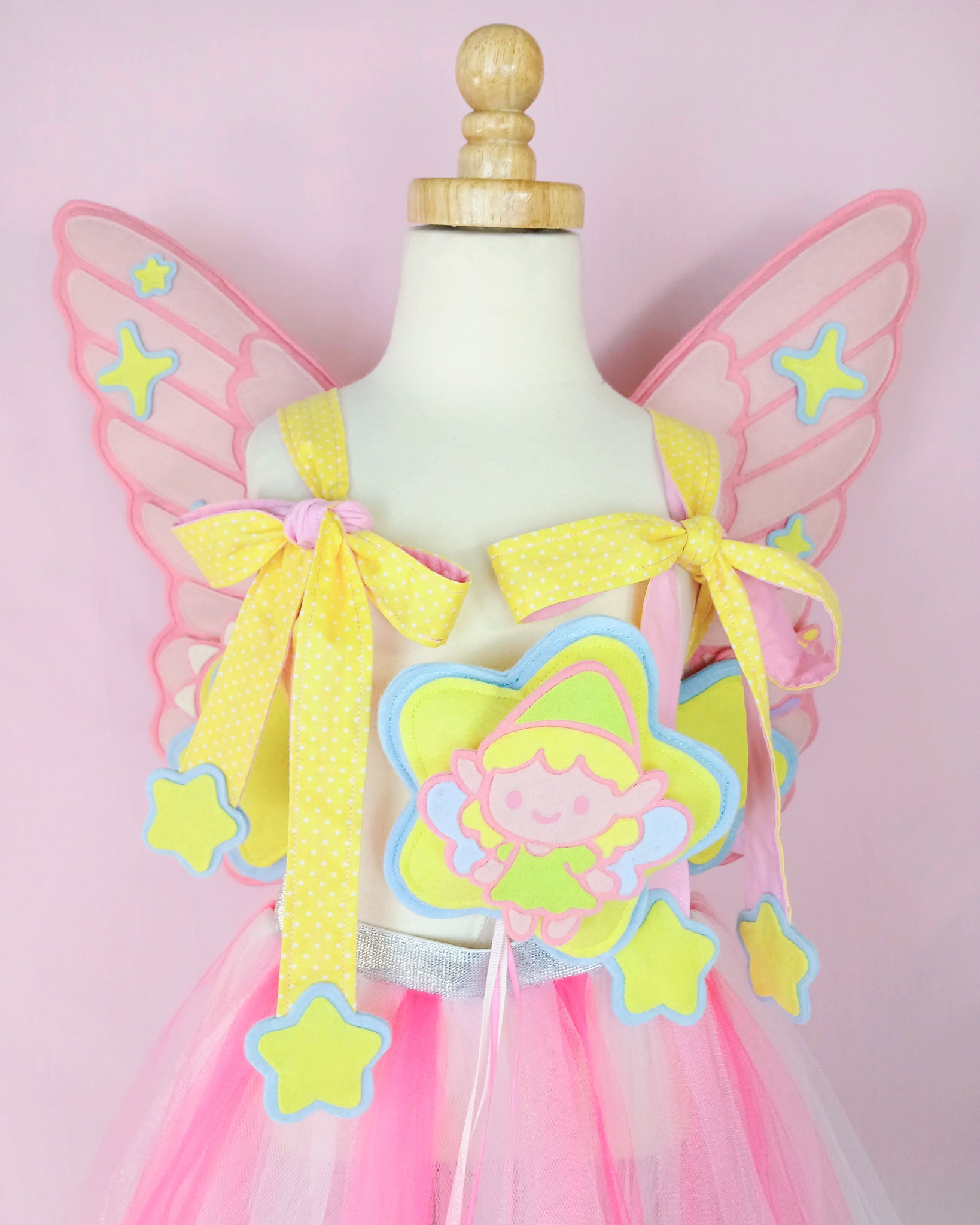 Premium bespoke fairy wings in wool felt with unicorn charm and polka dot straps, heirloom costume for birthdays.