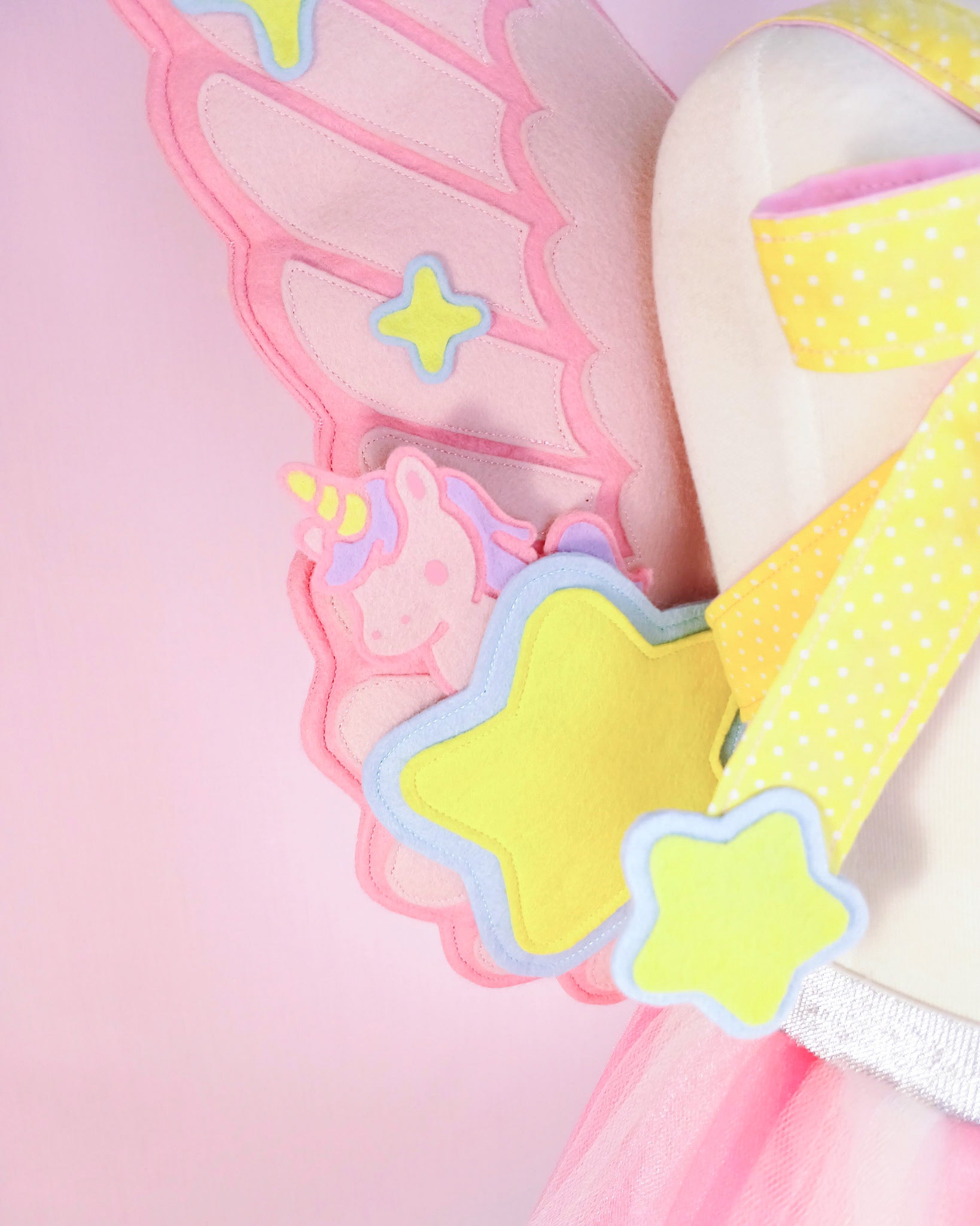 Close-up of charm pocket detail on pink felt fairy wings, handcrafted heirloom costume for imaginative play.