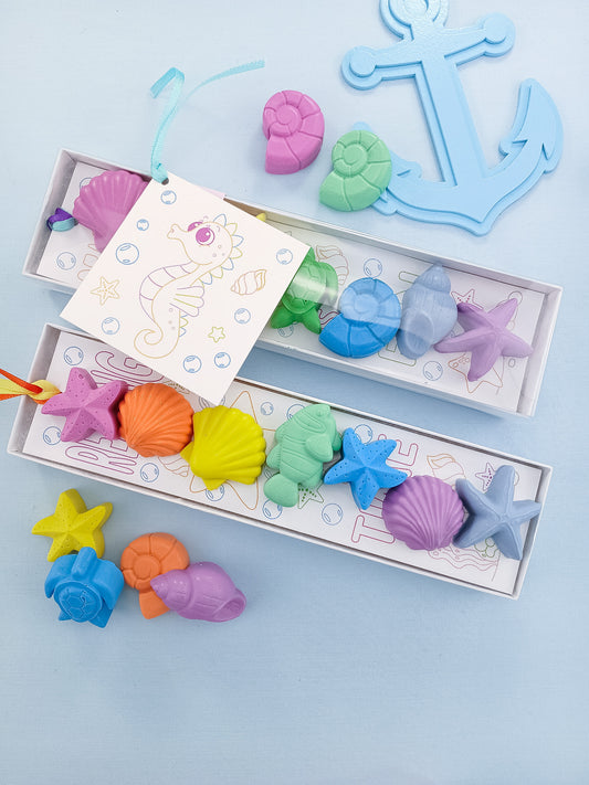 Clear gift box with pastel rainbow sea creature crayons and ocean coloring card, handmade non-toxic art gift for kids.
