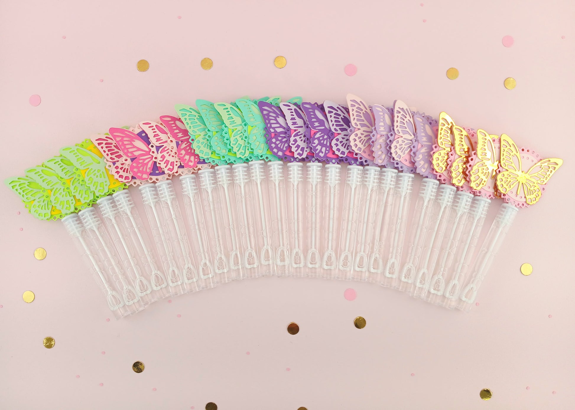 Colorful rainbow assortment of 30 butterfly bubble wands arranged in a fan shape on a pink confetti background, perfect for party supplies or classroom gifts