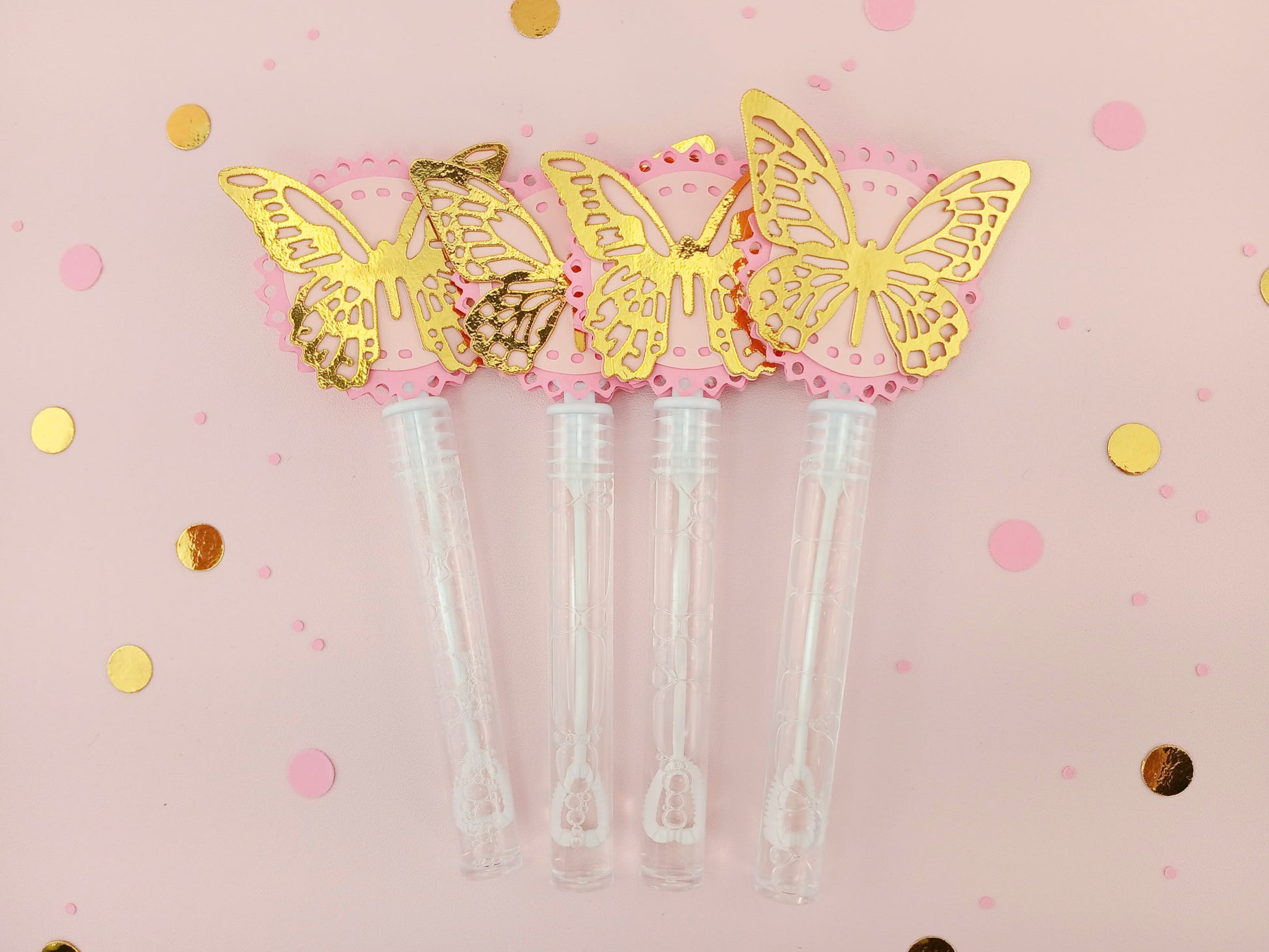 Set of four pink and gold foil butterfly bubble wands with shiny layered toppers, great for princess parties, bridal showers, or luxury favor bags